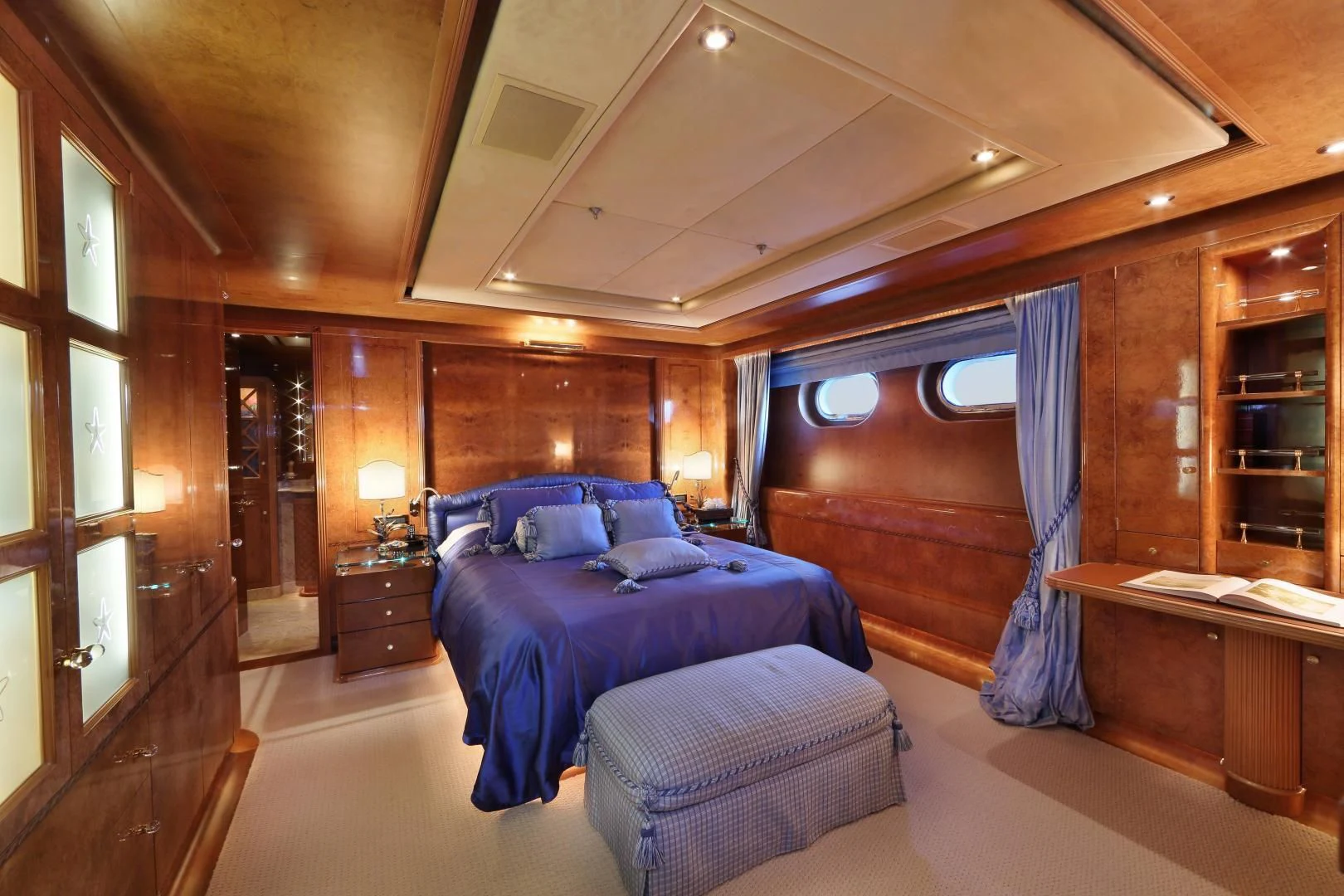 a bedroom with a bed and a desk aboard AQUA MARE Yacht for Sale