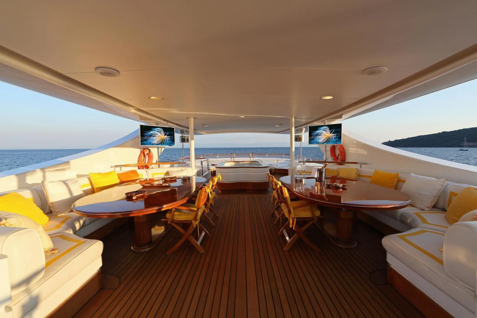 a room with a table and chairs aboard AQUA MARE Yacht for Sale