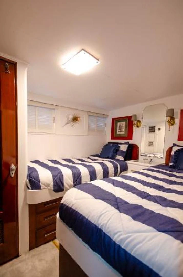 a bedroom with two beds aboard LIBERTY LOVE Yacht for Sale