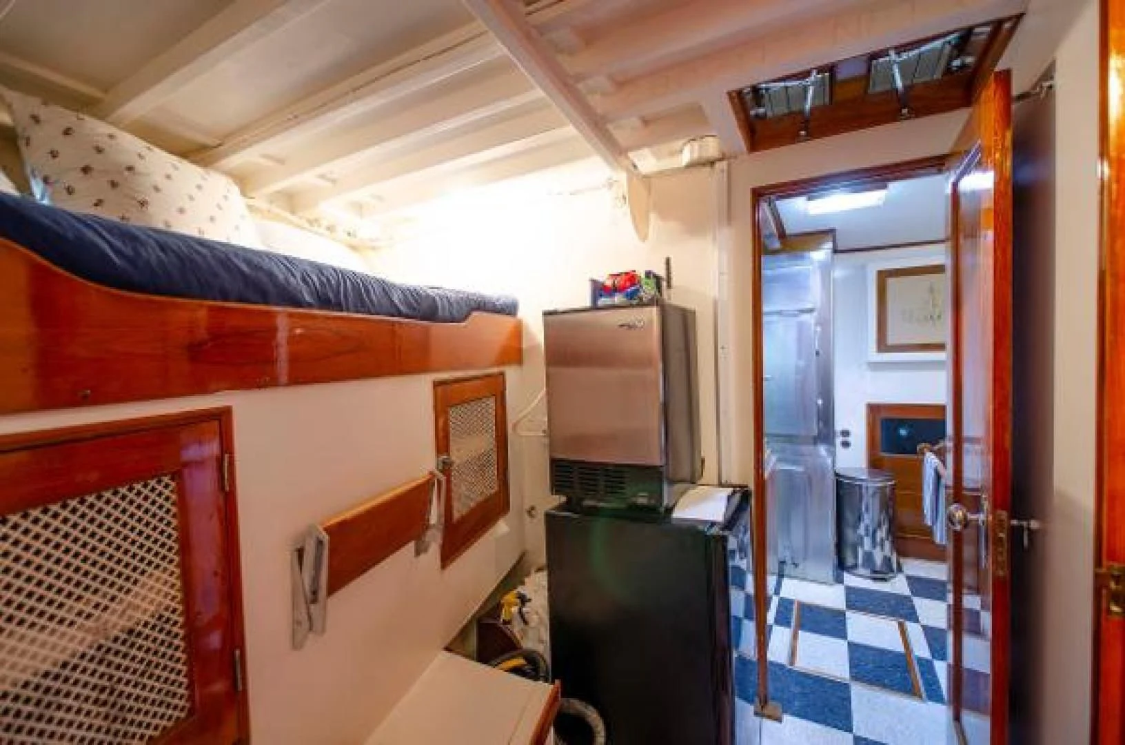 a room with a bed and desk aboard LIBERTY LOVE Yacht for Sale