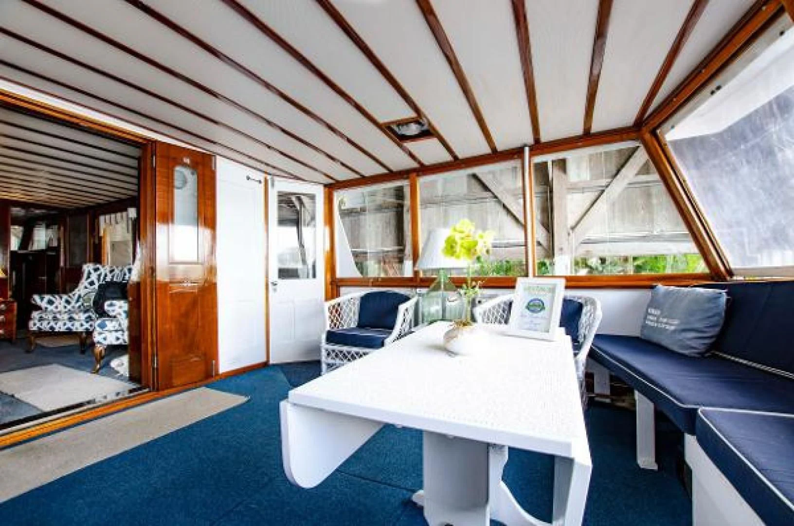 a room with a table and chairs aboard LIBERTY LOVE Yacht for Sale