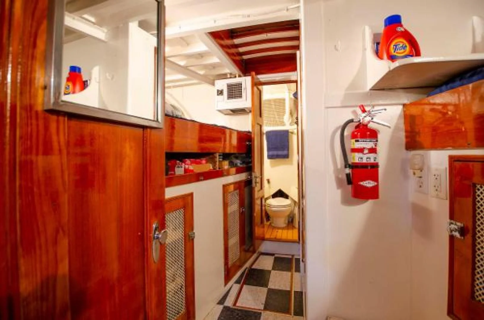 a small kitchen with a fridge aboard LIBERTY LOVE Yacht for Sale