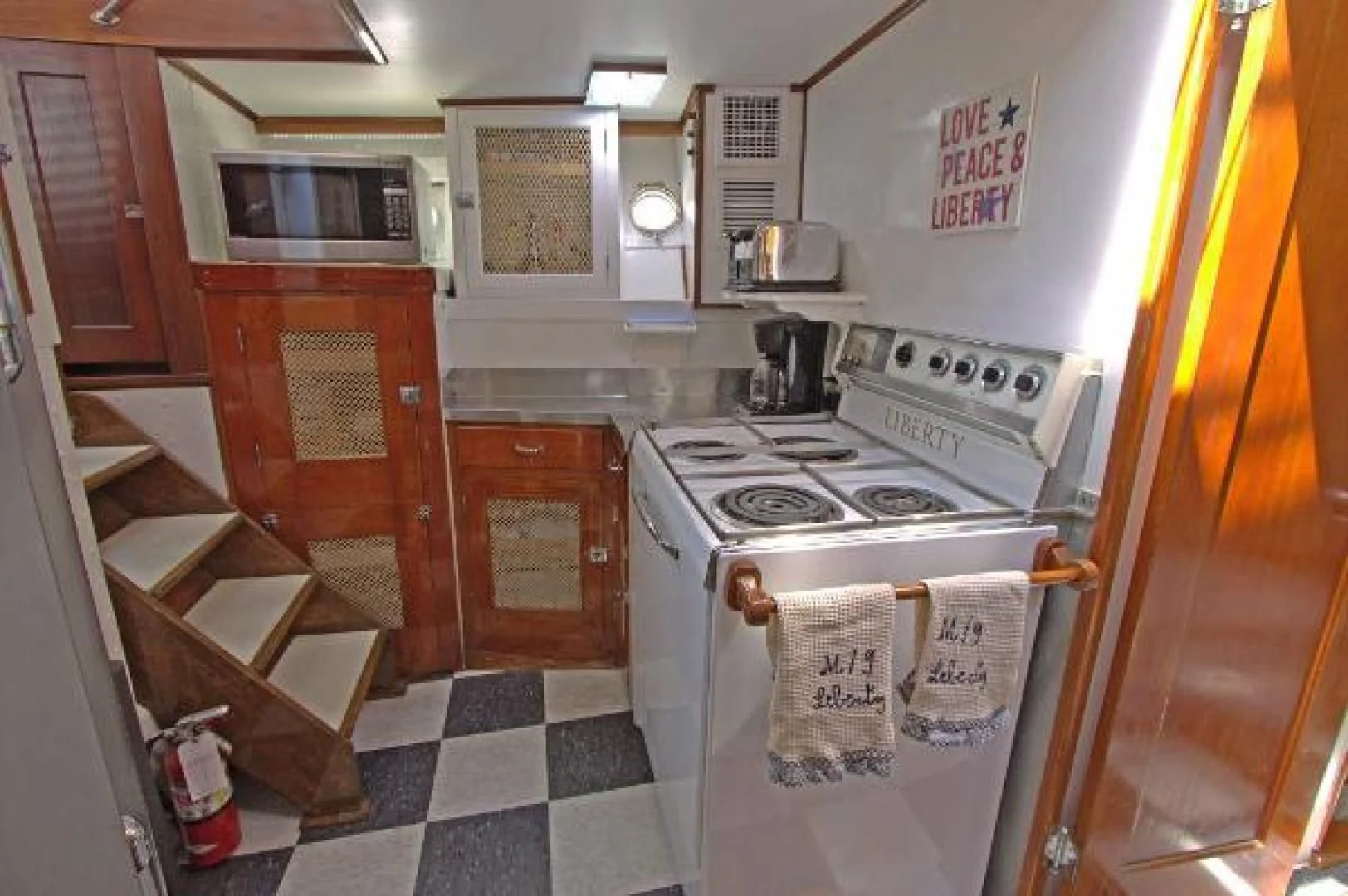 a kitchen with a stove and cabinets aboard LIBERTY LOVE Yacht for Sale