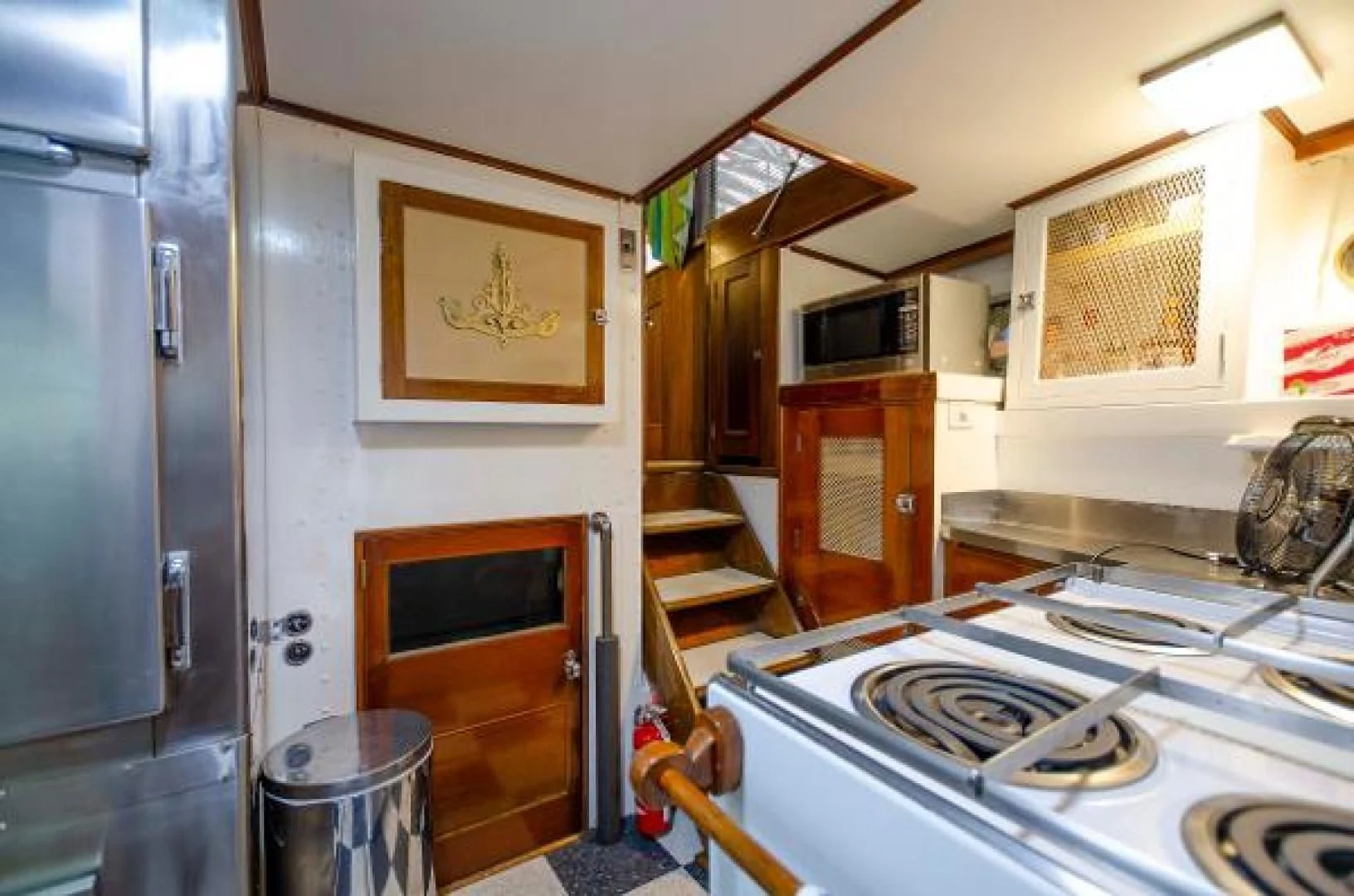 a kitchen with a fridge and a sink aboard LIBERTY LOVE Yacht for Sale