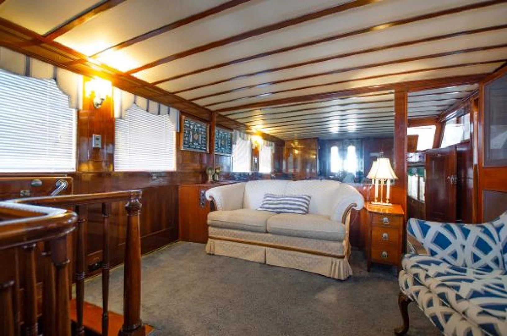 a living room with a couch and a table aboard LIBERTY LOVE Yacht for Sale
