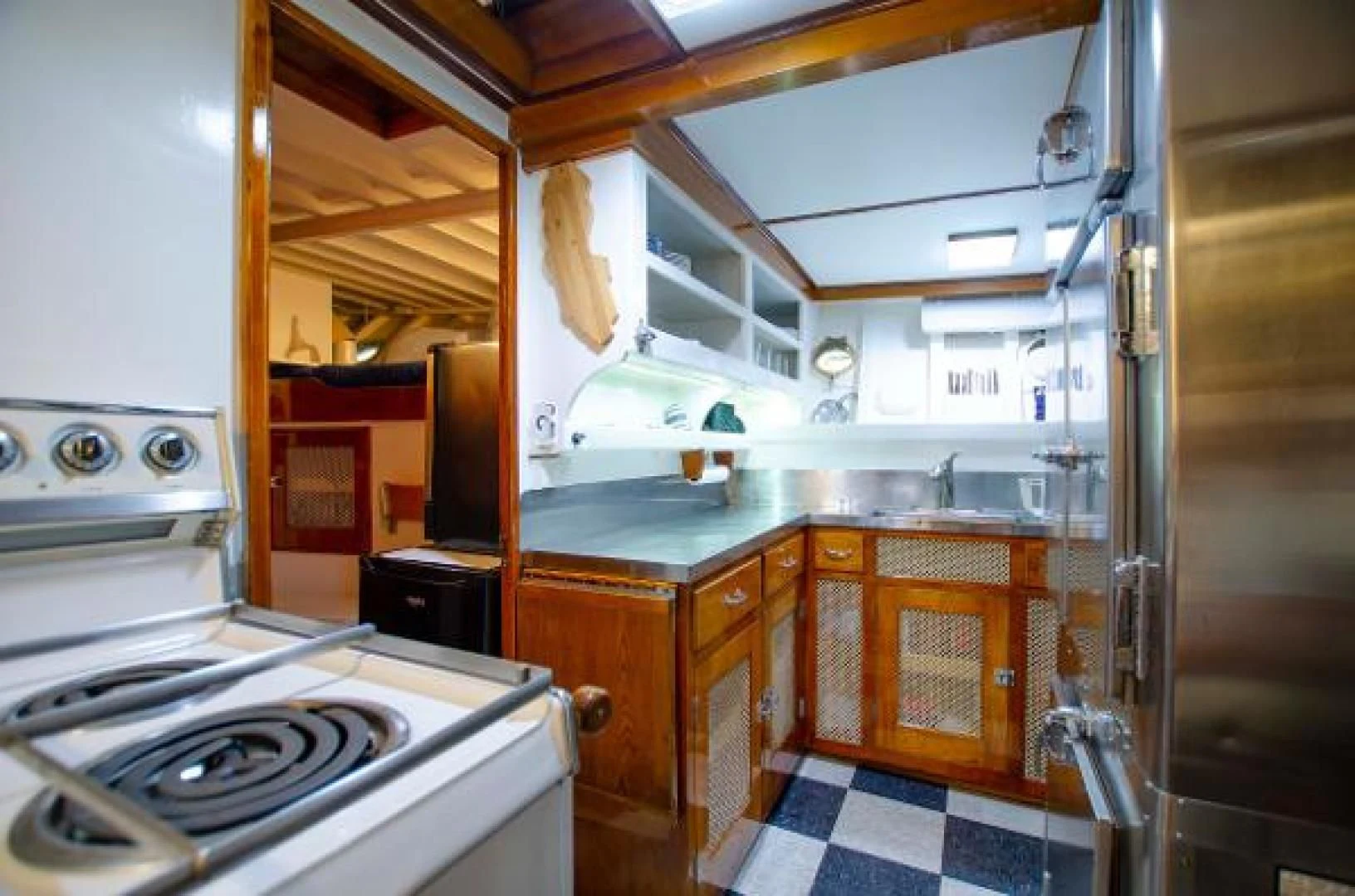 a kitchen with a stove and cabinets aboard LIBERTY LOVE Yacht for Sale