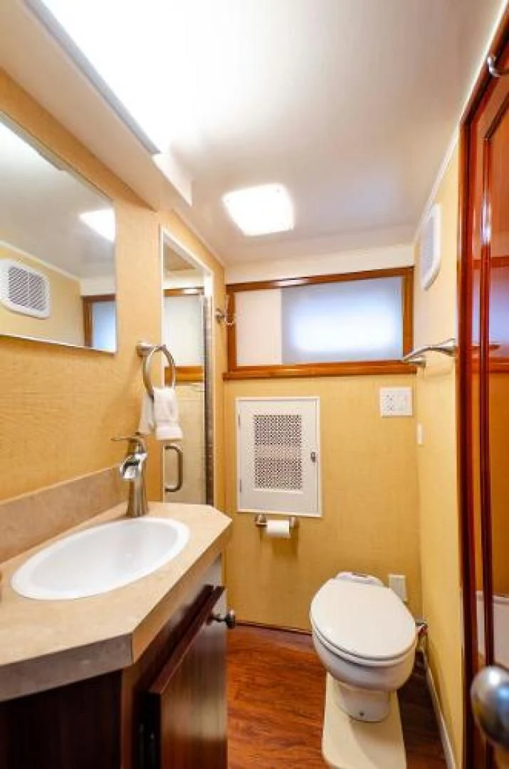 a bathroom with a sink and toilet aboard LIBERTY LOVE Yacht for Sale
