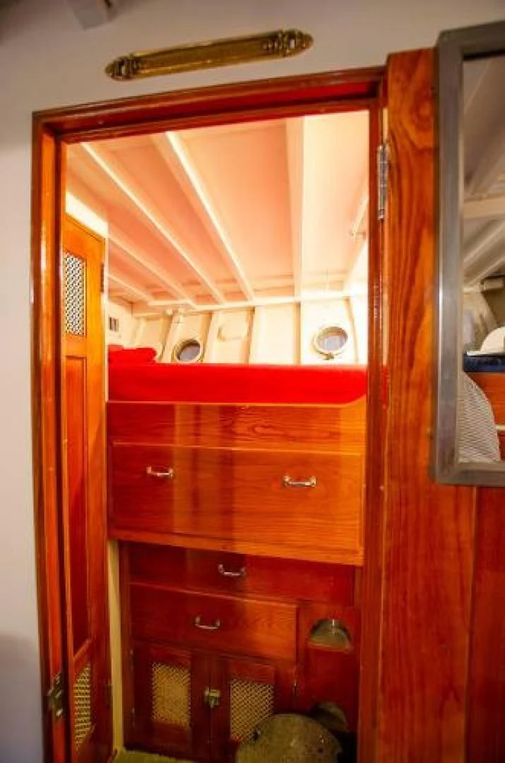 a wooden cabinet with drawers aboard LIBERTY LOVE Yacht for Sale