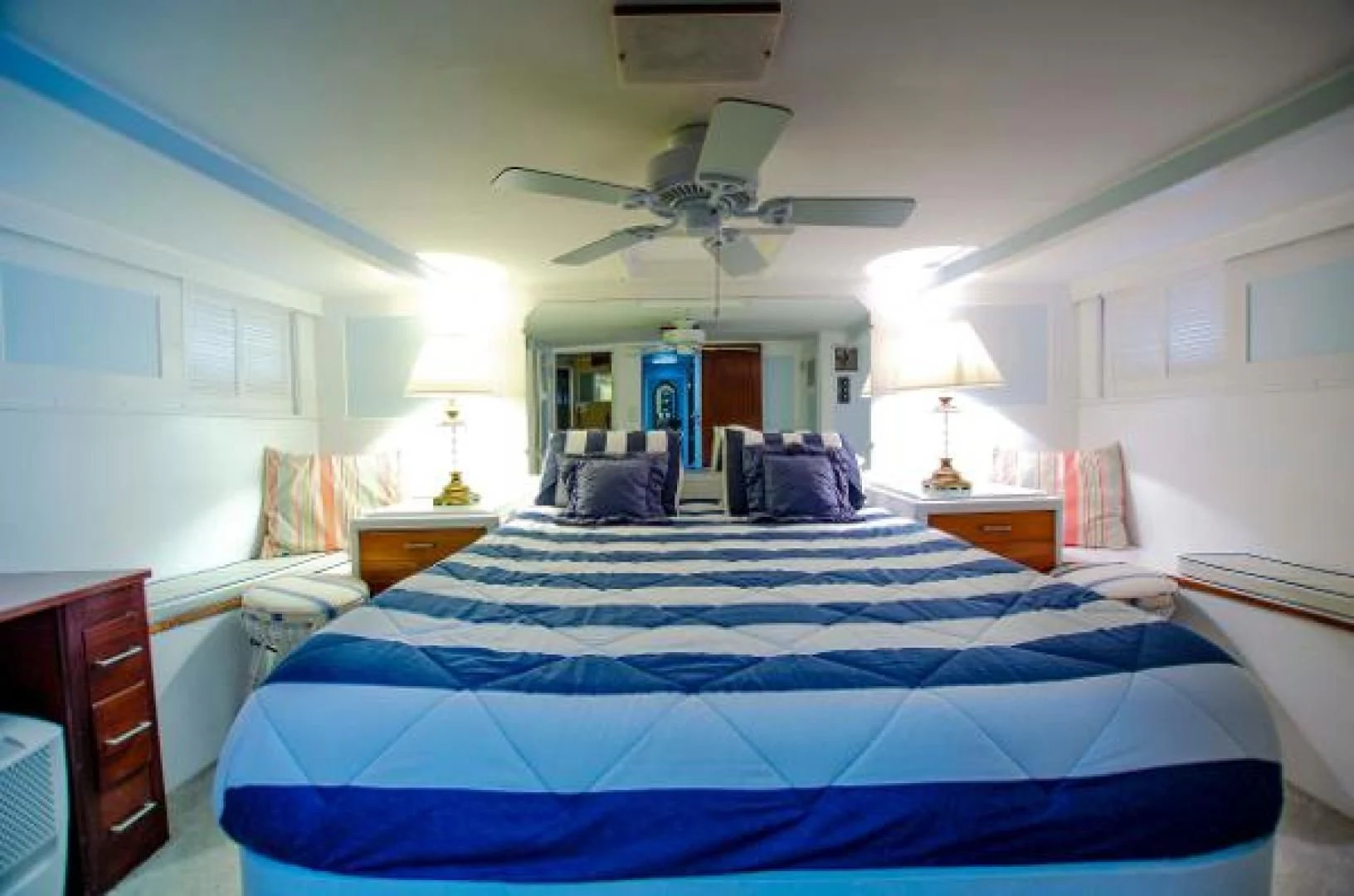 a bedroom with a ceiling fan aboard LIBERTY LOVE Yacht for Sale
