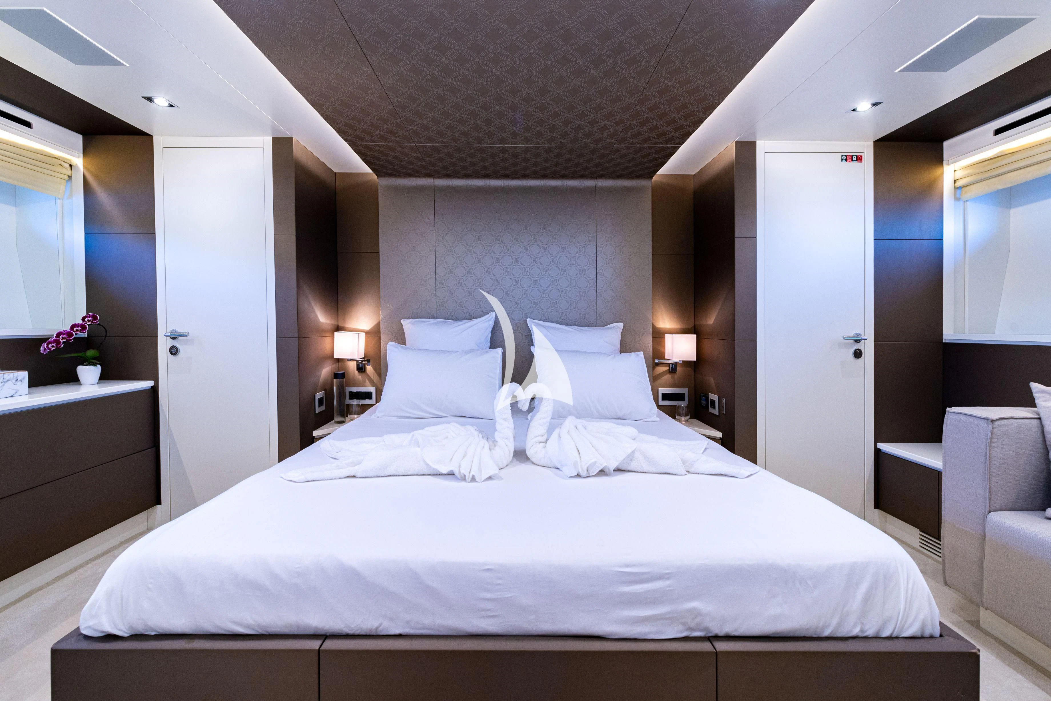 a large bed in a hotel room aboard MANATEA Yacht for Sale