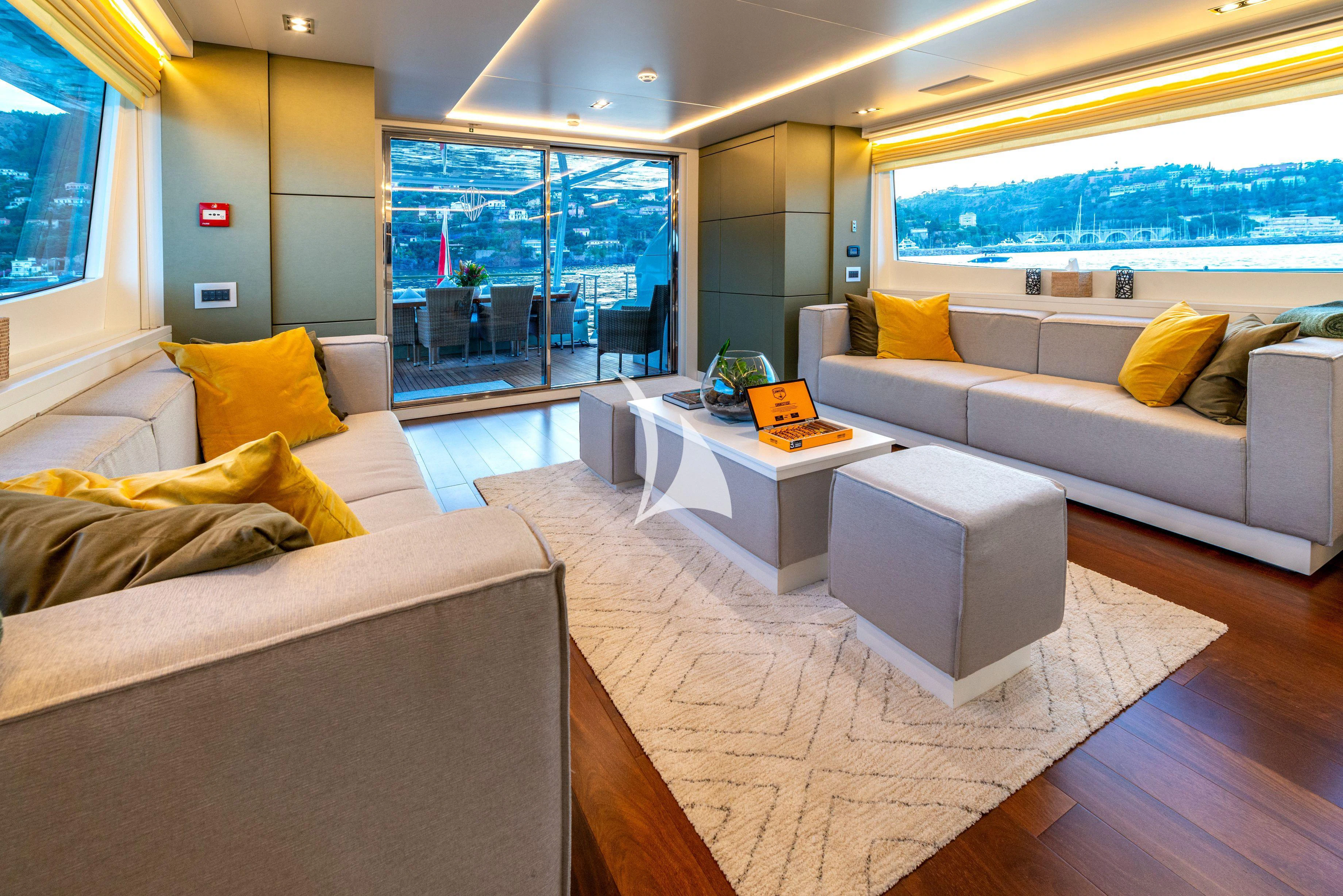 a living room with a couch and a table aboard MANATEA Yacht for Sale