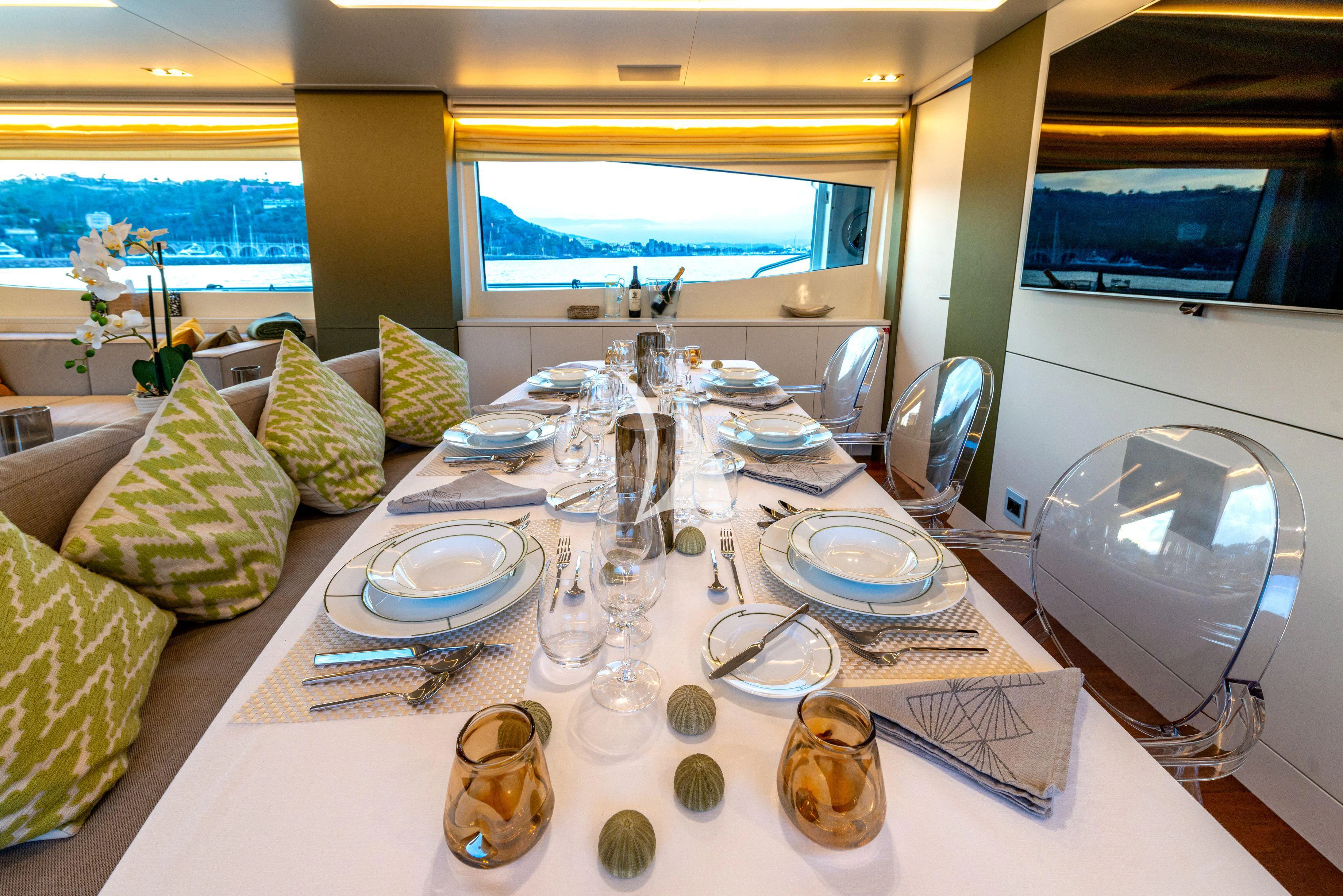 a table with plates and glasses on it aboard MANATEA Yacht for Sale