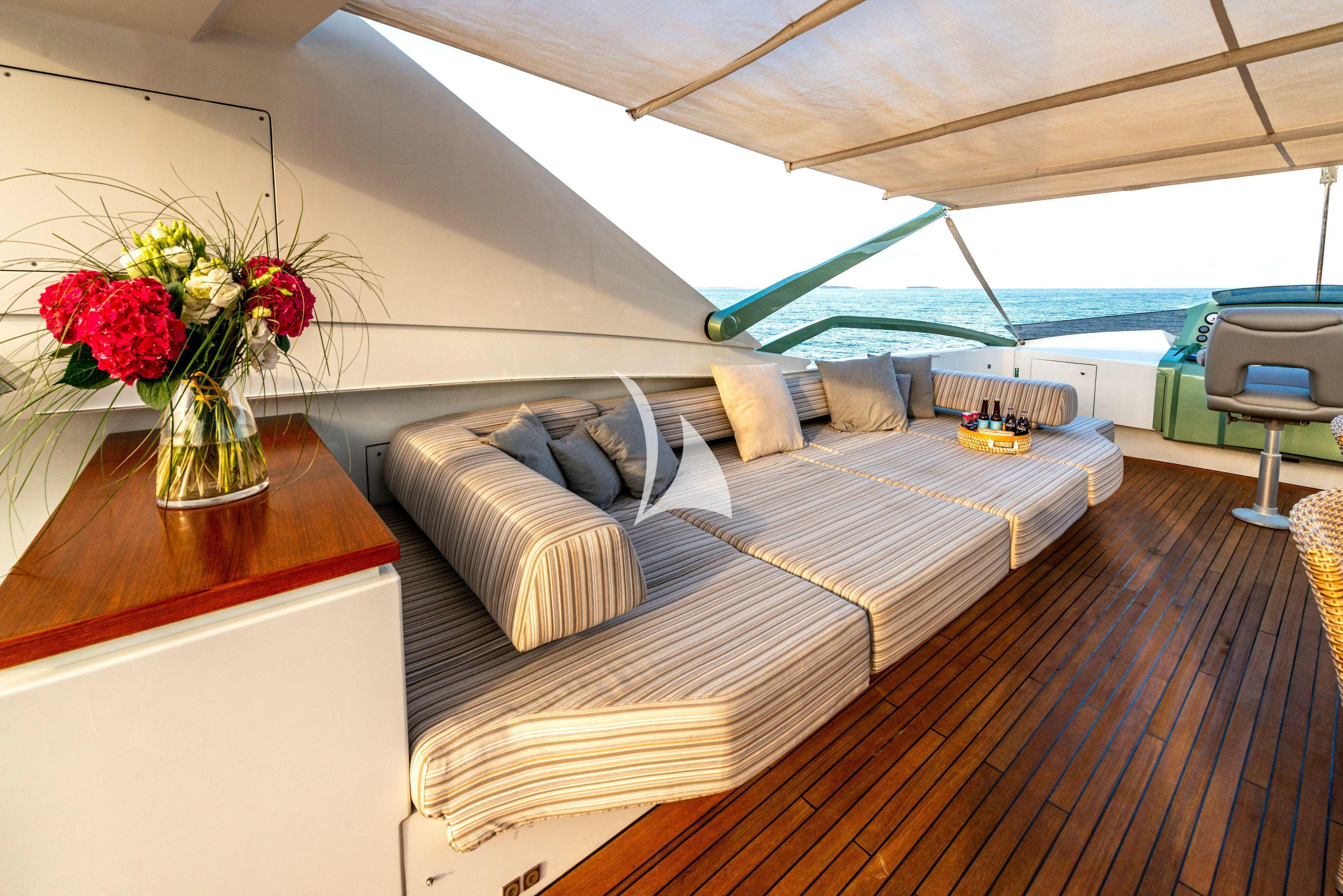 a bed with a flower vase on top of it aboard MANATEA Yacht for Sale