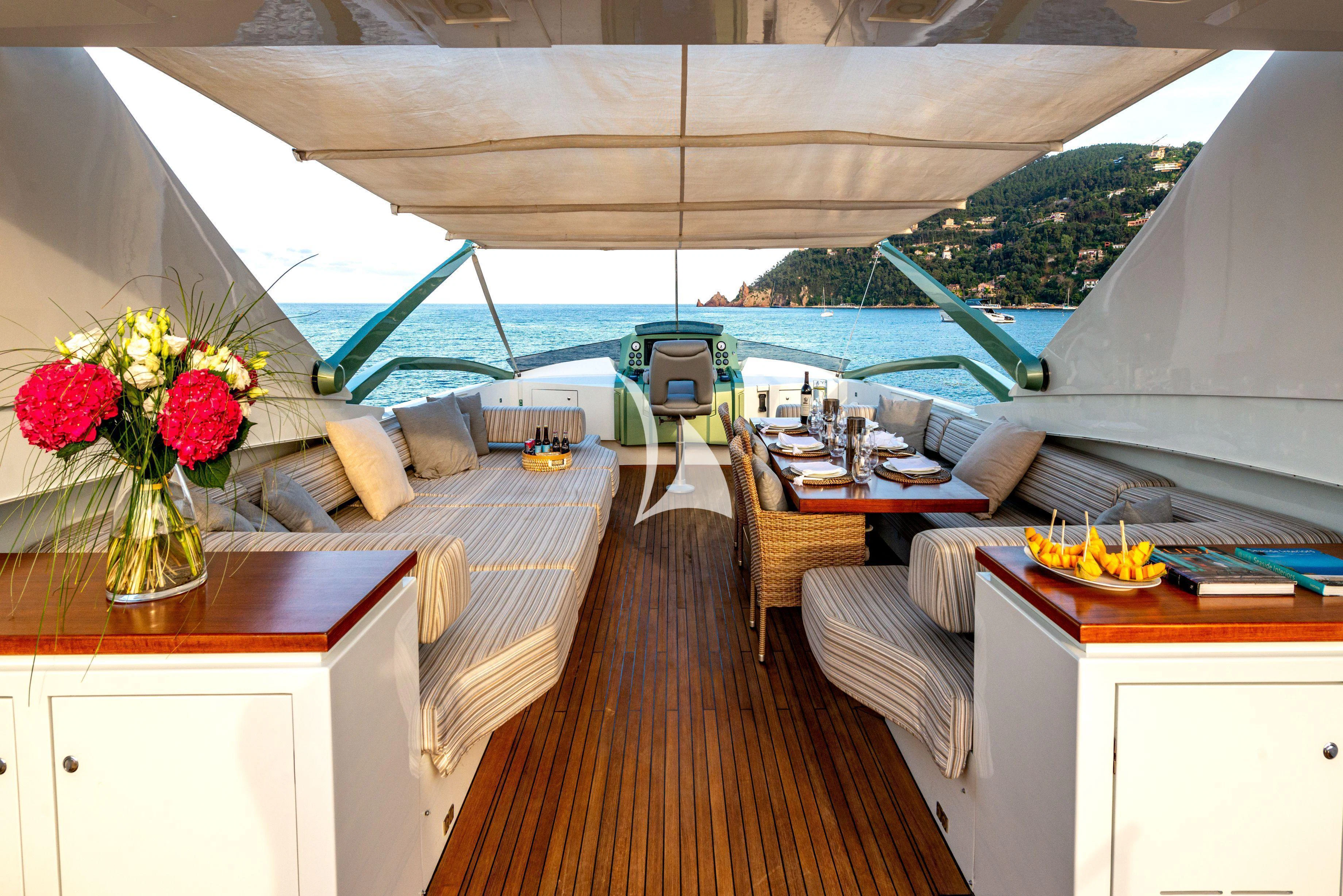 a room with a bed and a table with a vase of flowers aboard MANATEA Yacht for Sale