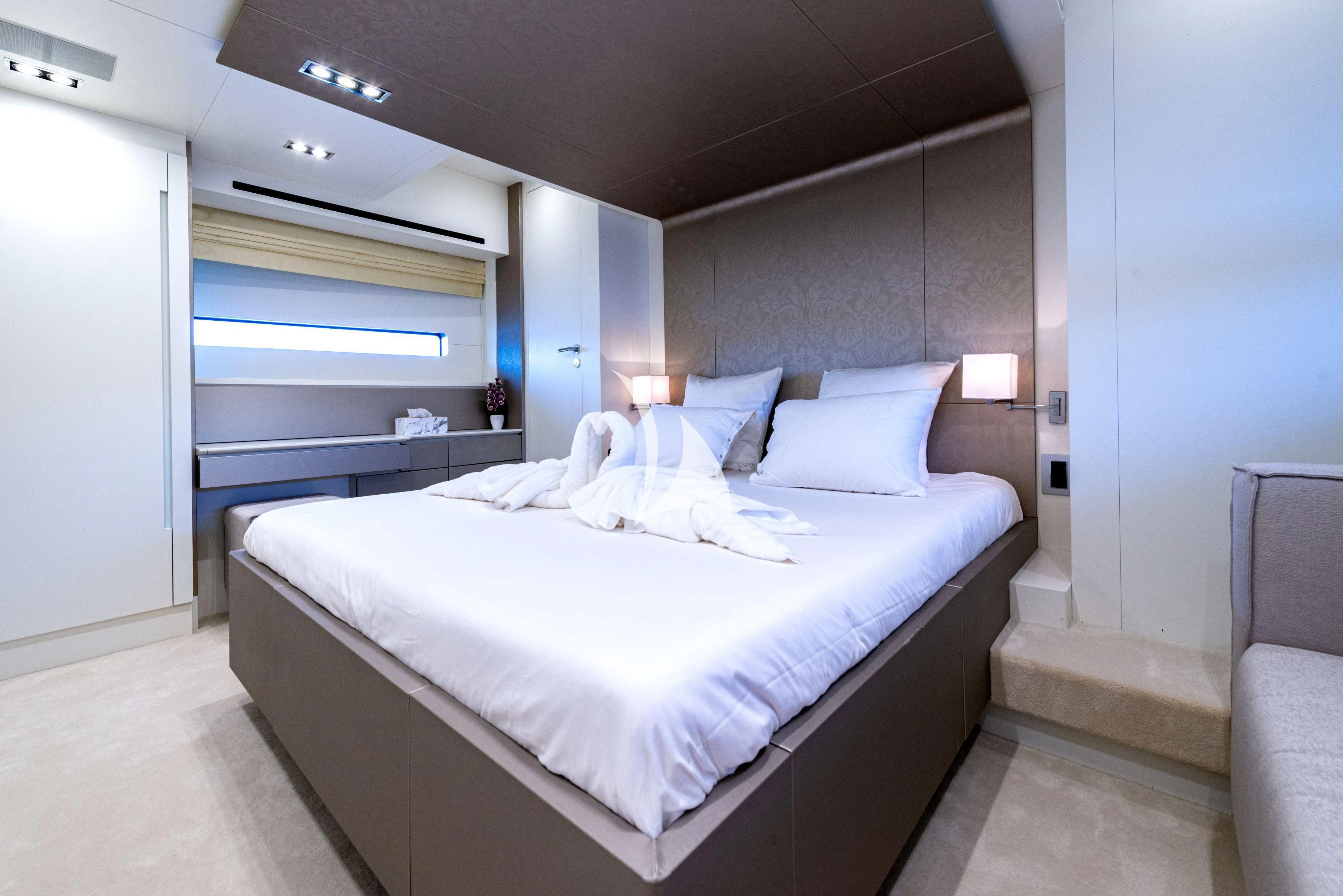a room with a bed and a chair aboard MANATEA Yacht for Sale