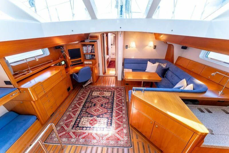 a room with a couch and a rug aboard LEONORE Yacht for Sale