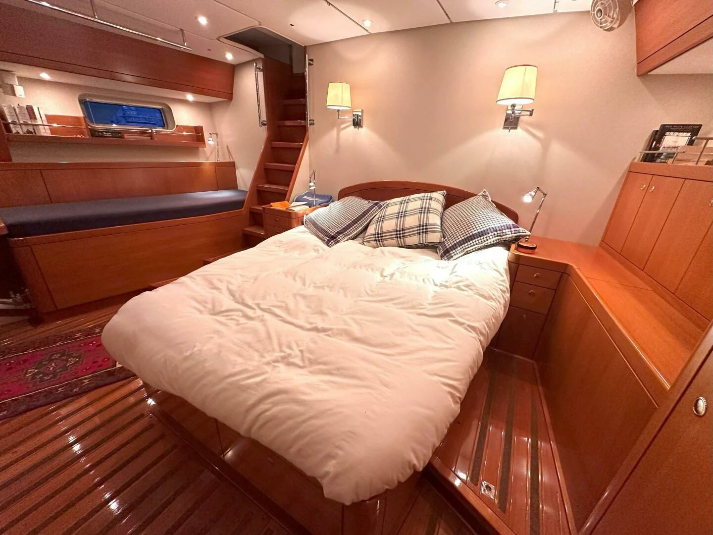 a bedroom with a bed and a desk aboard LEONORE Yacht for Sale