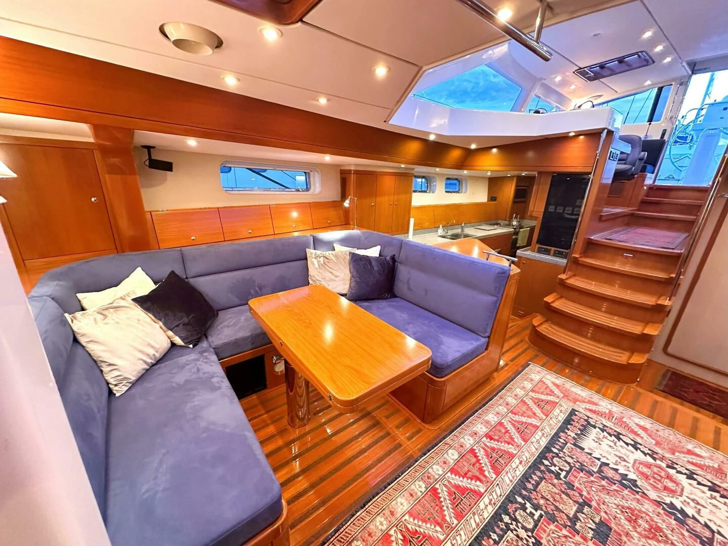 a living room with a couch and a rug aboard LEONORE Yacht for Sale