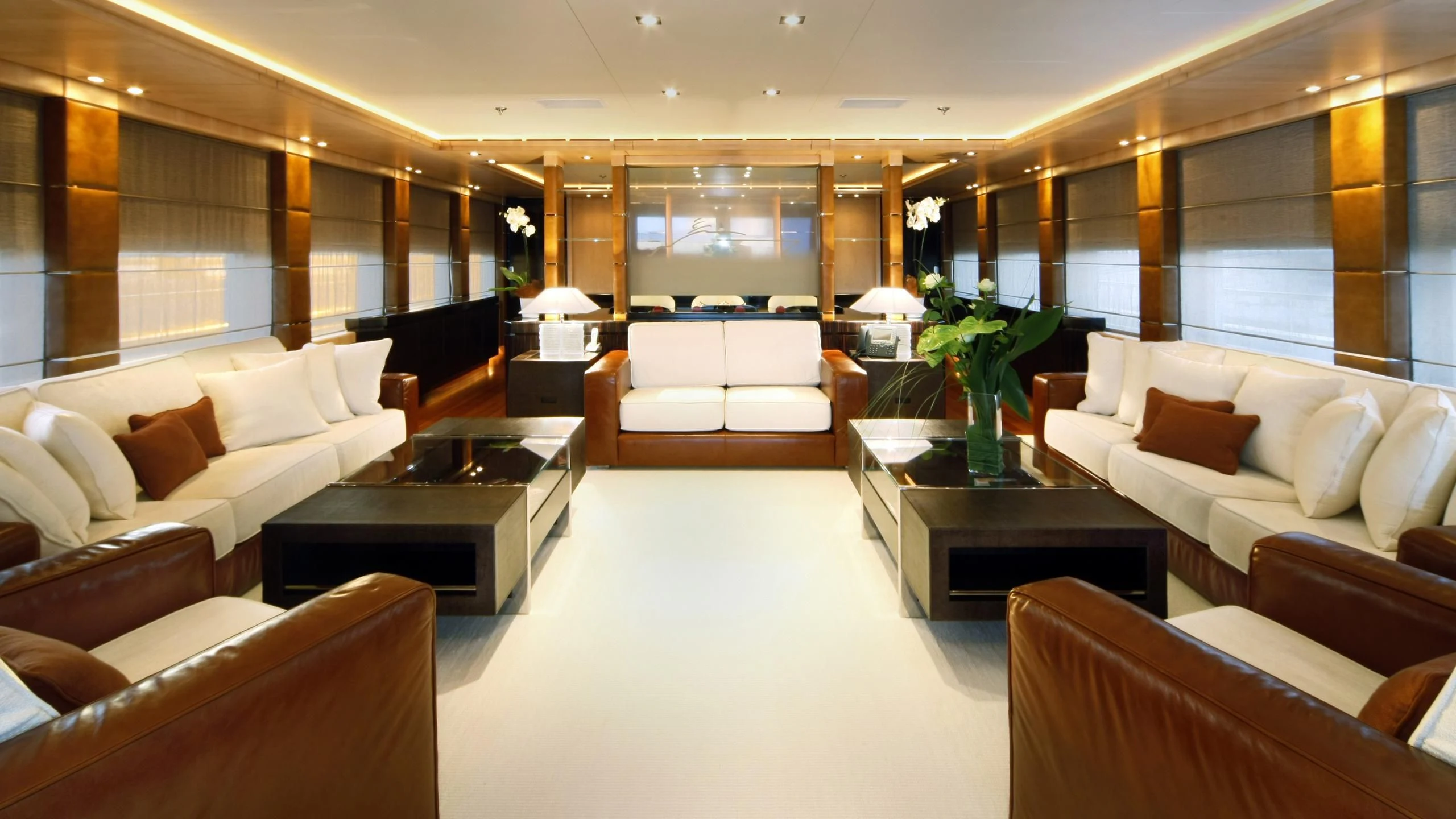 a large room with couches and tables aboard MUZA Yacht for Sale