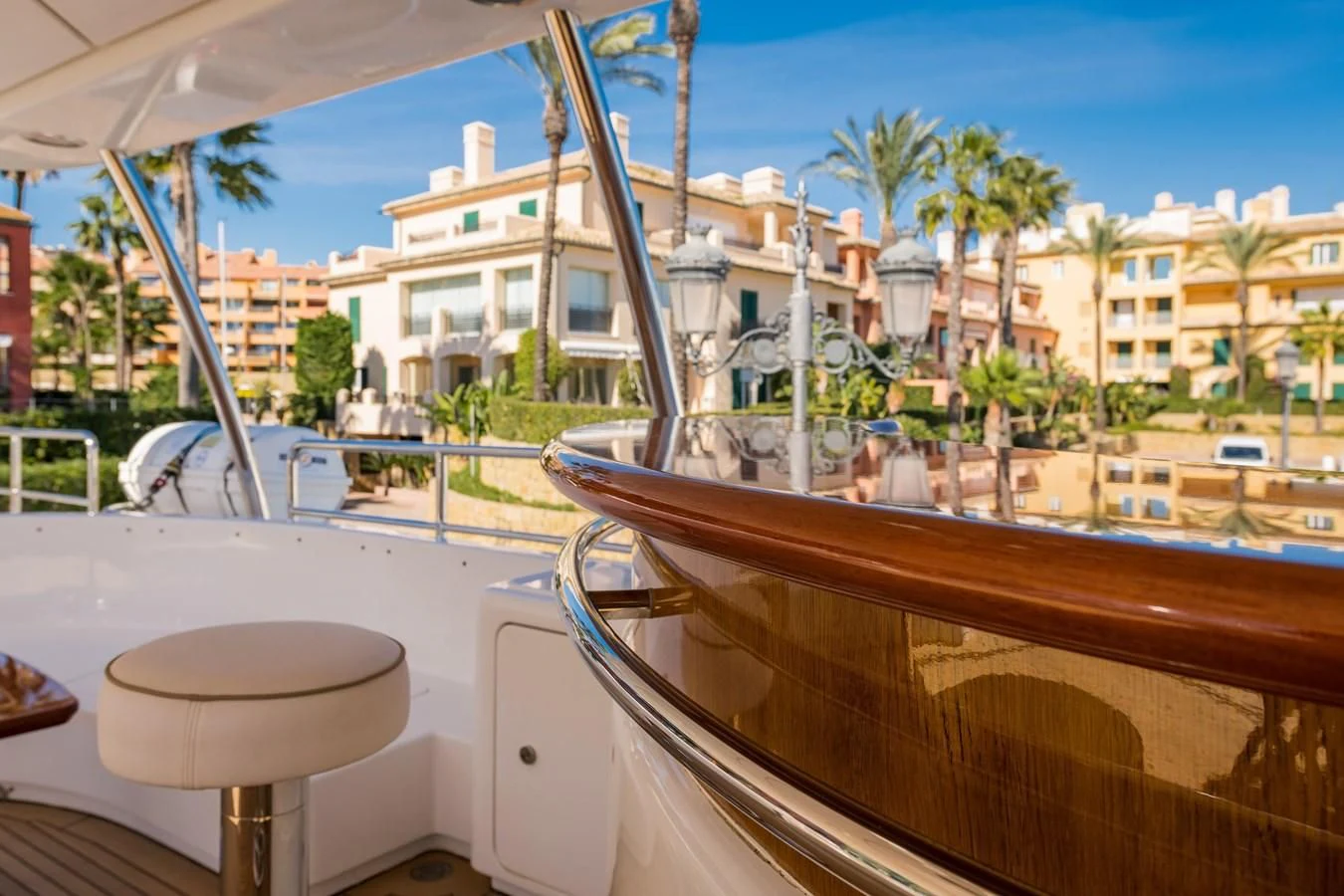 a deck with a swing set and a building in the background aboard LA BELLA SARA III Yacht for Sale