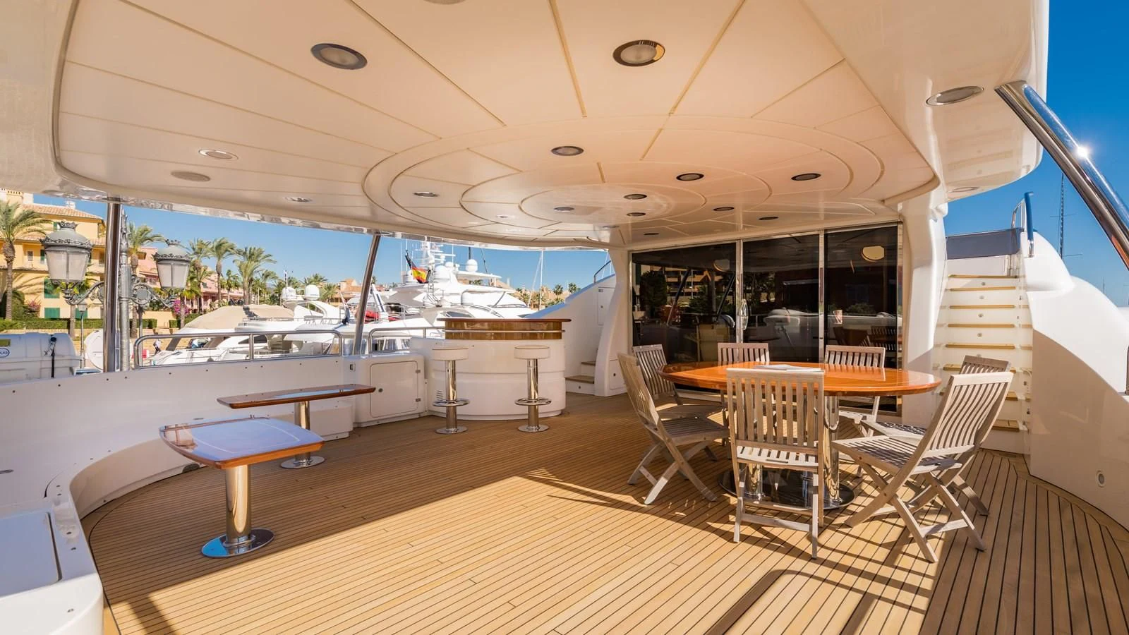 a room with tables and chairs aboard LA BELLA SARA III Yacht for Sale