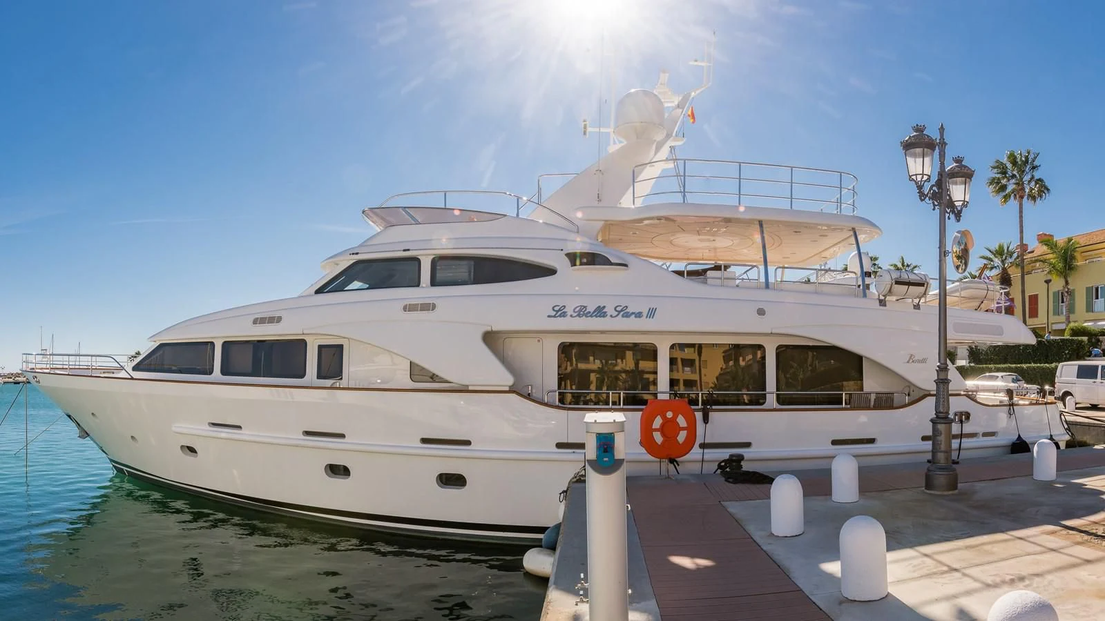 a large white yacht docked at a dock aboard LA BELLA SARA III Yacht for Sale