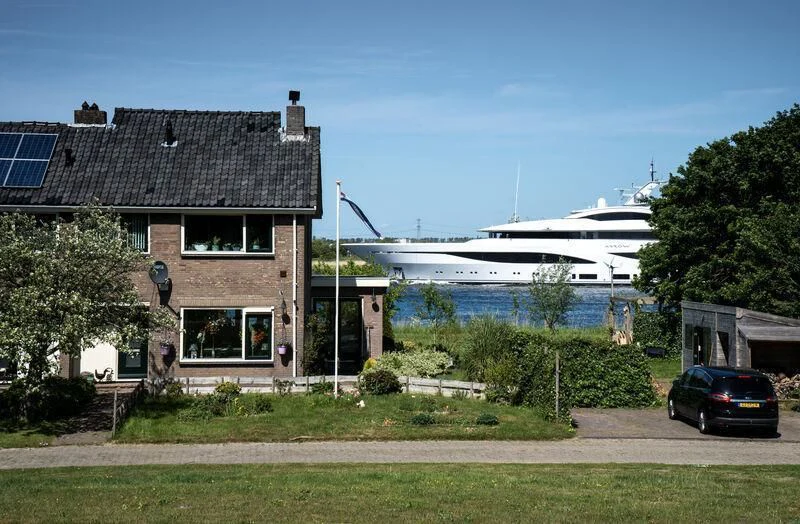 a boat parked in front of a house aboard ARROW Yacht for Sale