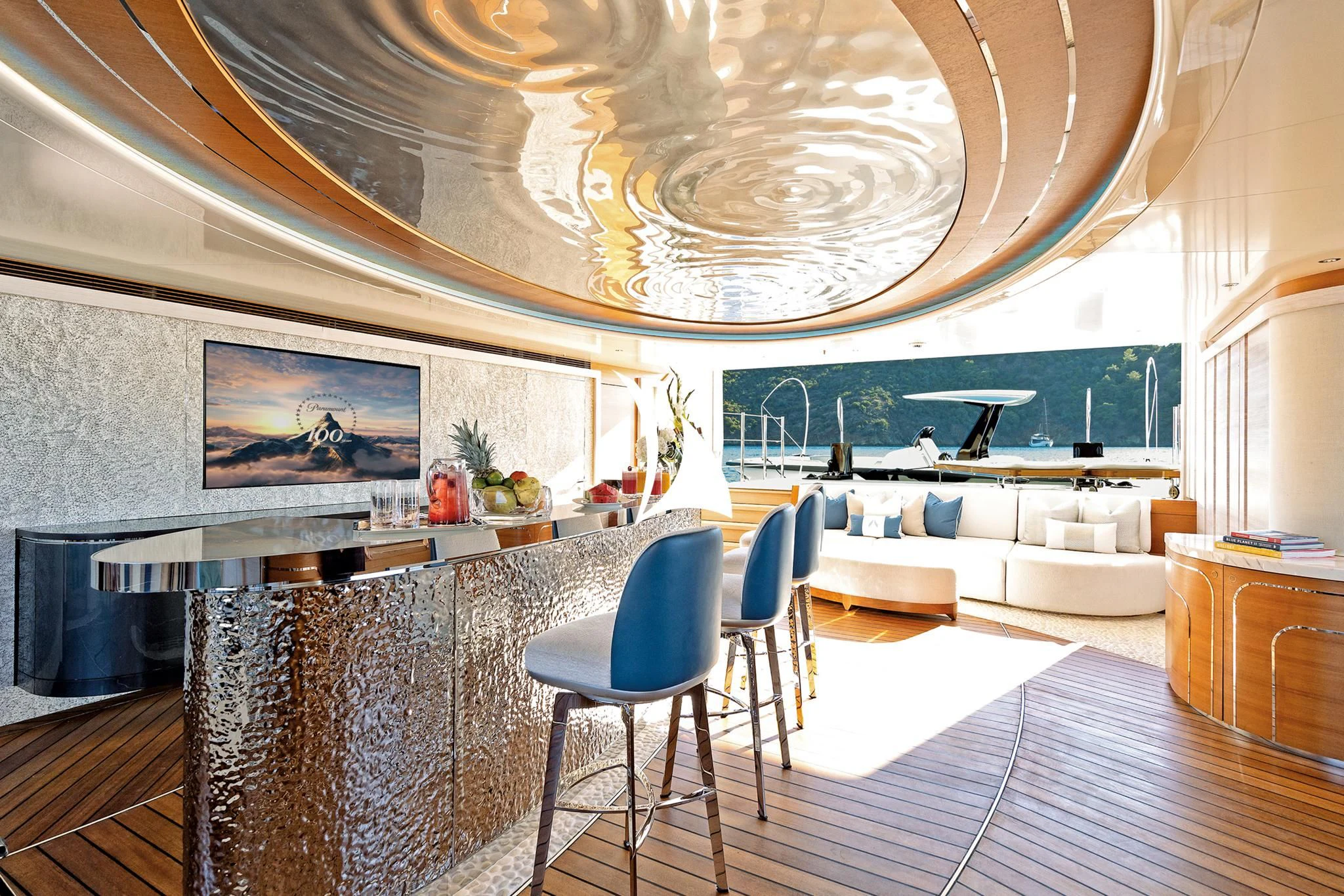 a room with a large chandelier and a white couch aboard ARROW Yacht for Sale