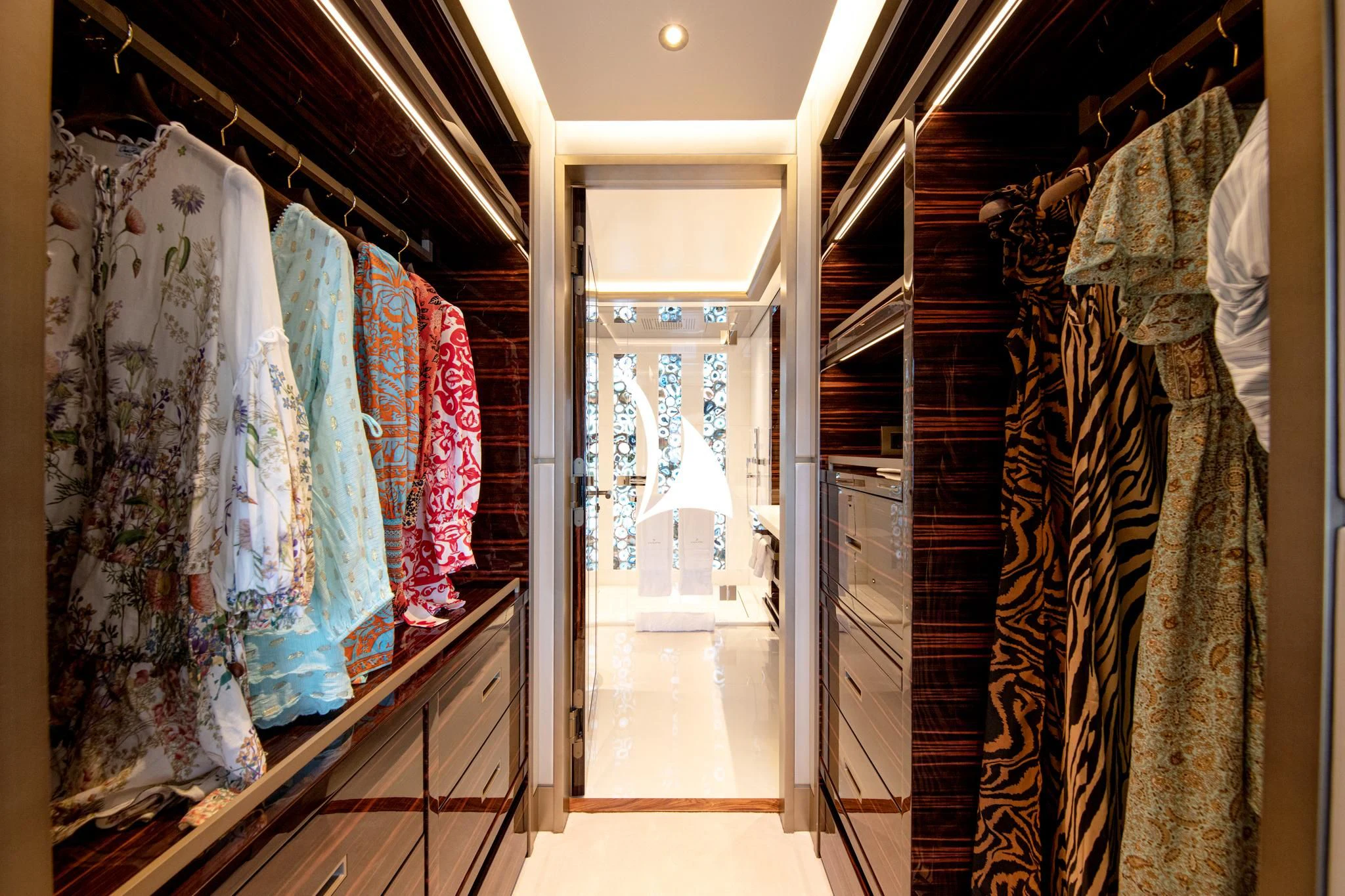 a room with a closet and clothes on the wall aboard ARROW Yacht for Sale