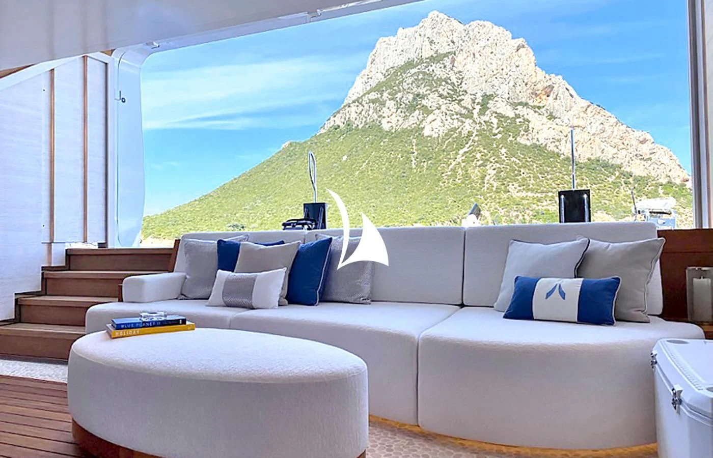 a large white couch with a large white wall and a large rock formation behind it aboard ARROW Yacht for Sale