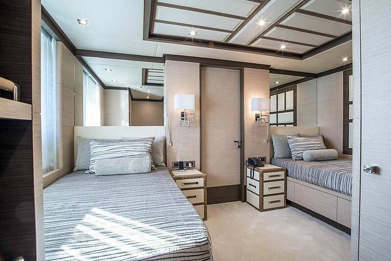 a bedroom with a bed and a desk aboard NELA Yacht for Charter