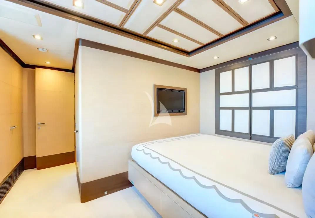 a room with a bed and a window aboard NELA Yacht for Charter