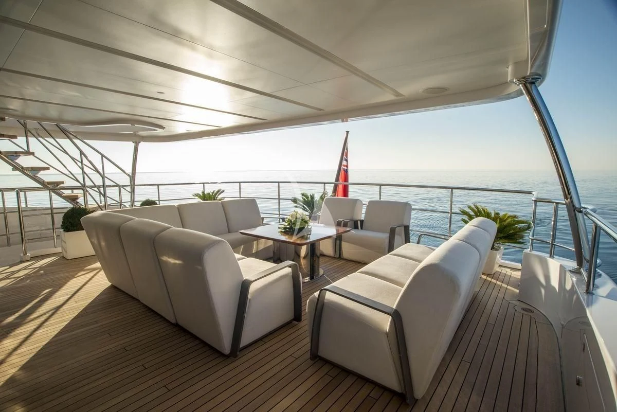 a large living room with a large balcony aboard NELA Yacht for Charter