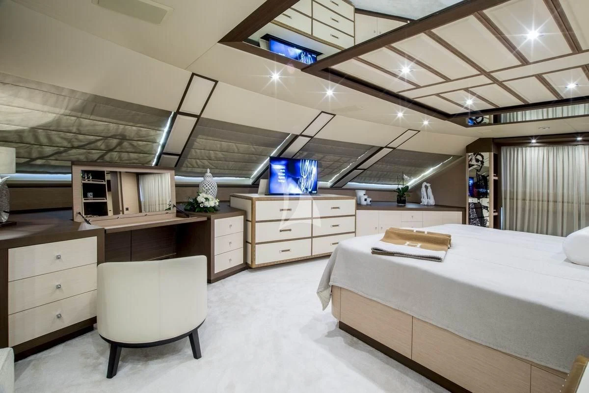 a room with a bed and a desk aboard NELA Yacht for Charter