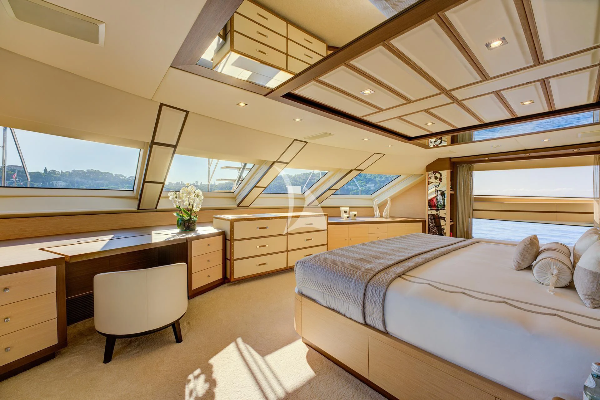 a bedroom with a bed and desk aboard NELA Yacht for Charter