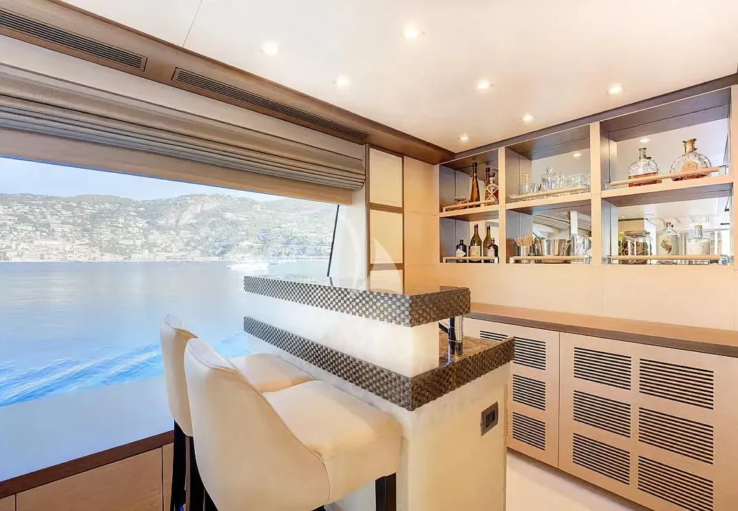 a room with a bed and a chair aboard NELA Yacht for Charter