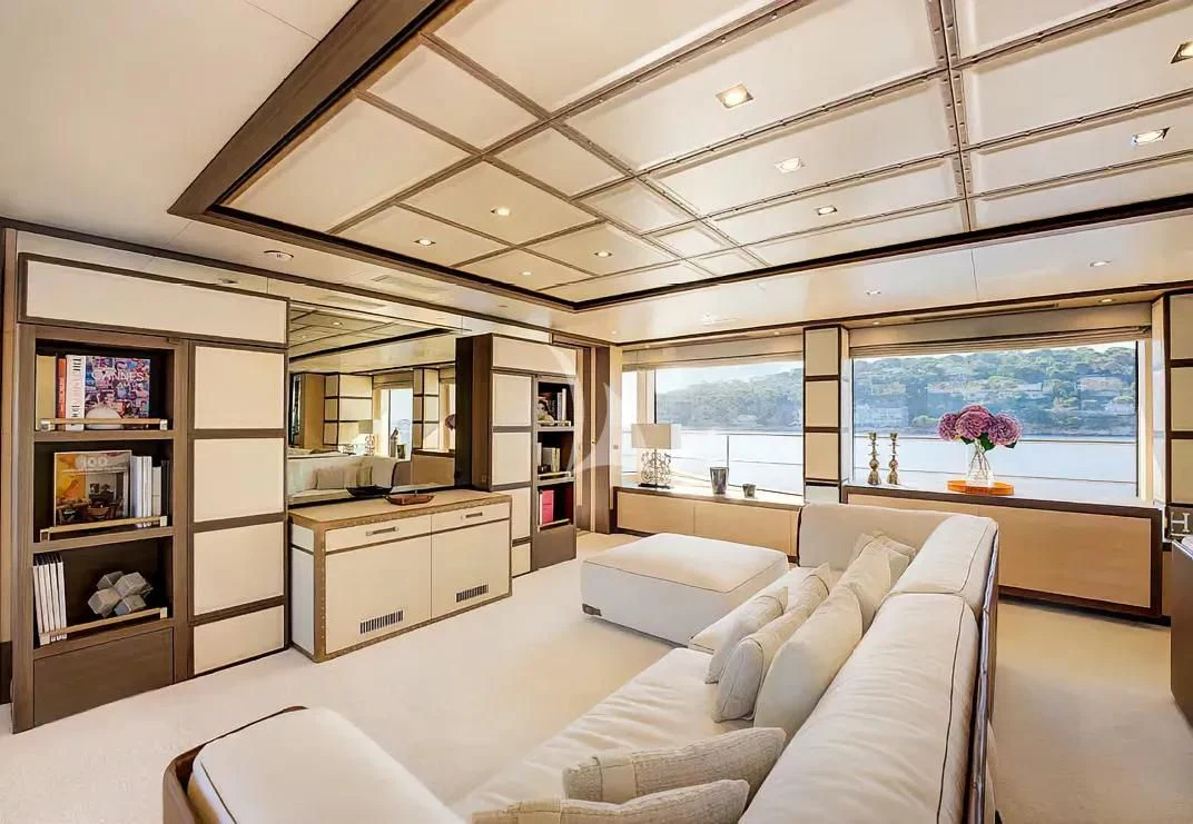 a room with a couch and a desk aboard NELA Yacht for Charter