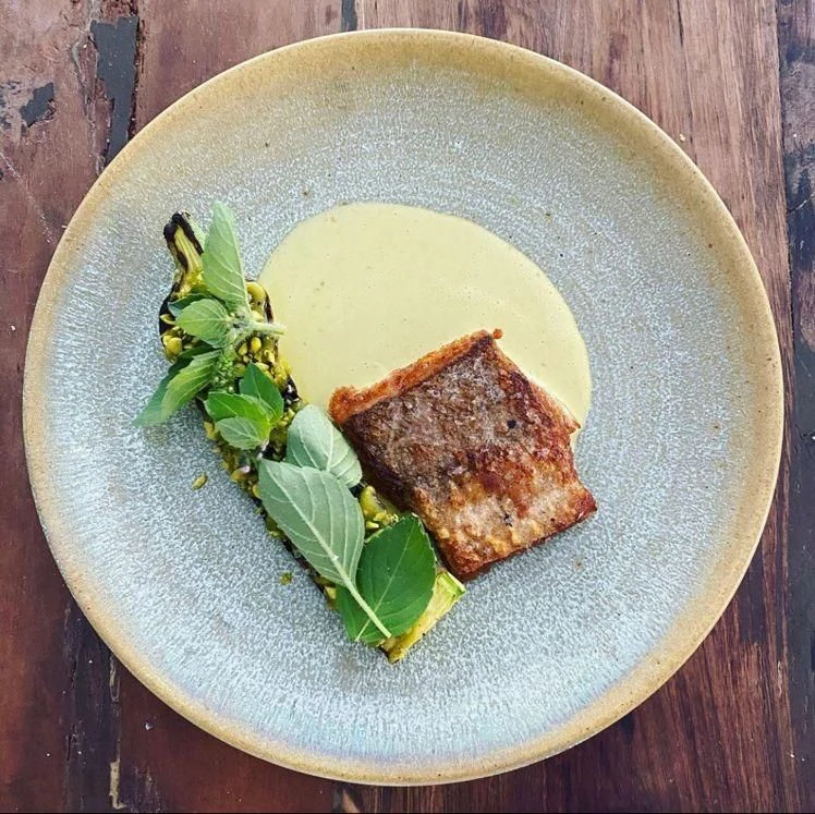 a plate of food aboard NELA Yacht for Charter