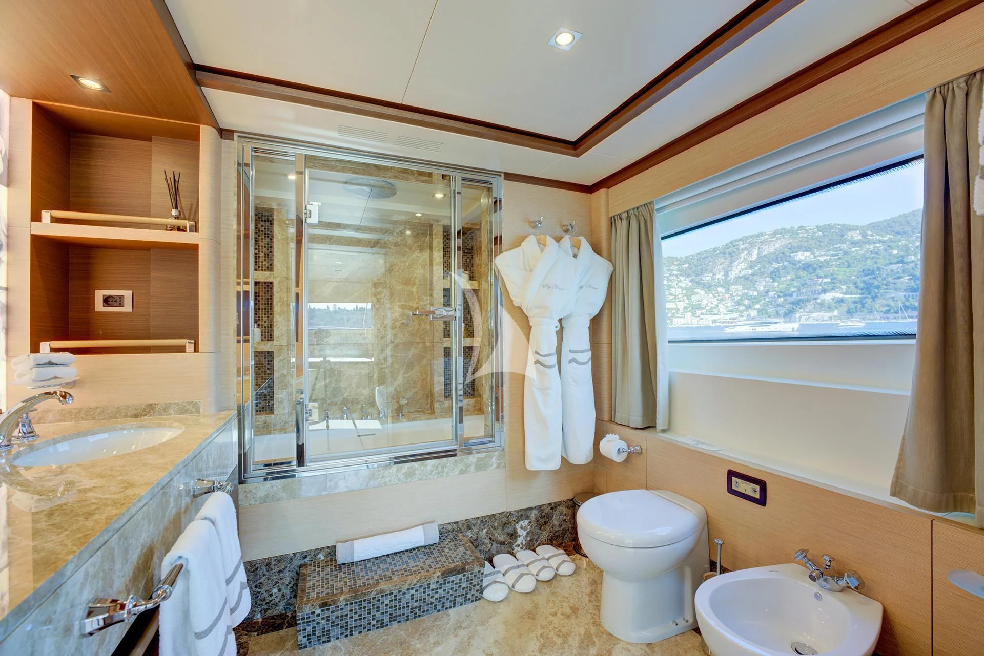 a bathroom with a large window aboard NELA Yacht for Charter