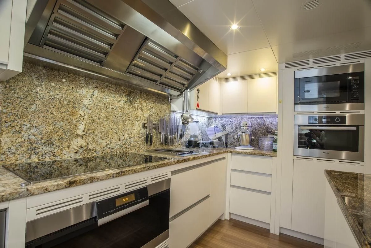 a kitchen with a marble counter top aboard NELA Yacht for Charter