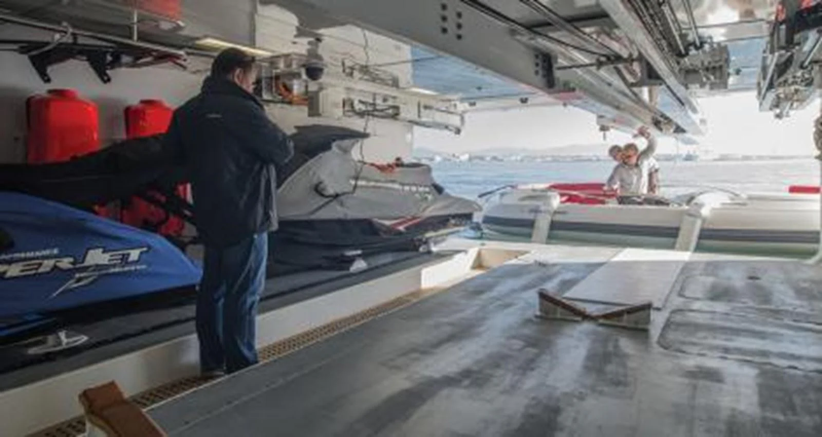 a man standing on a boat aboard NELA Yacht for Charter