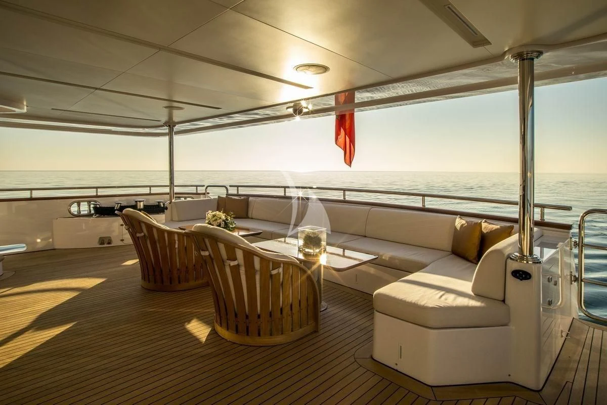 a room with a couch and chairs aboard NELA Yacht for Charter