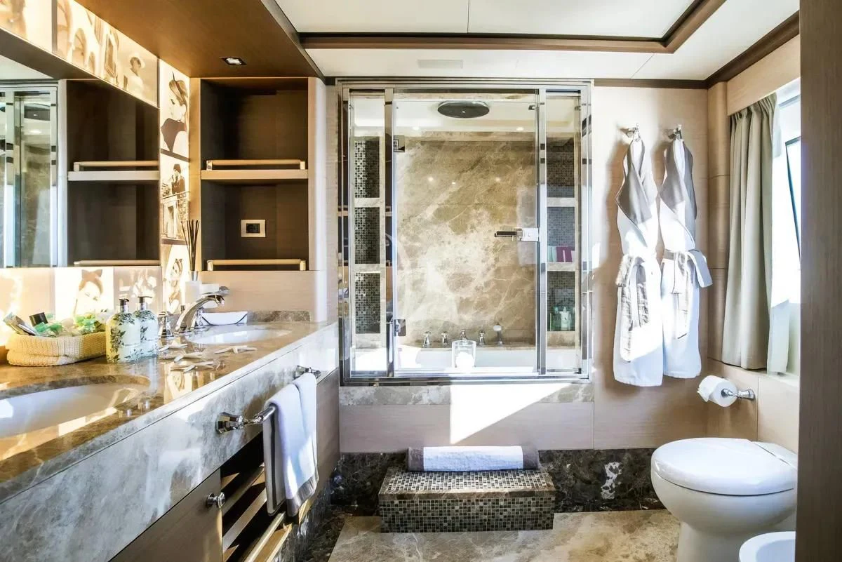 a bathroom with a large glass shower aboard NELA Yacht for Charter
