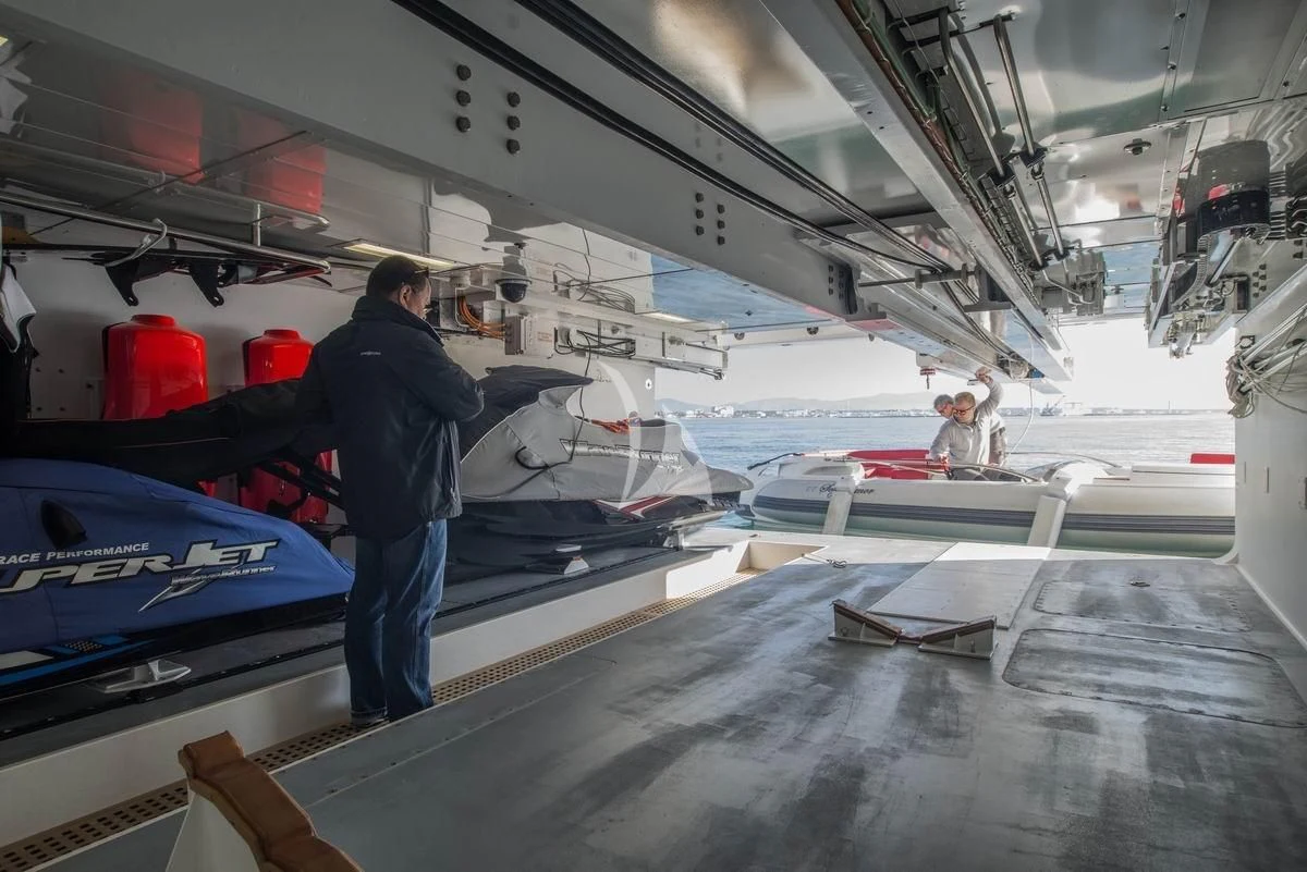 a person standing next to a boat aboard NELA Yacht for Charter