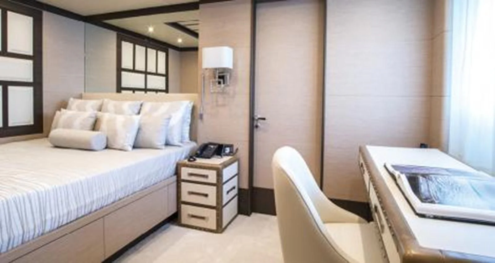 a room with a bed and a desk aboard NELA Yacht for Charter