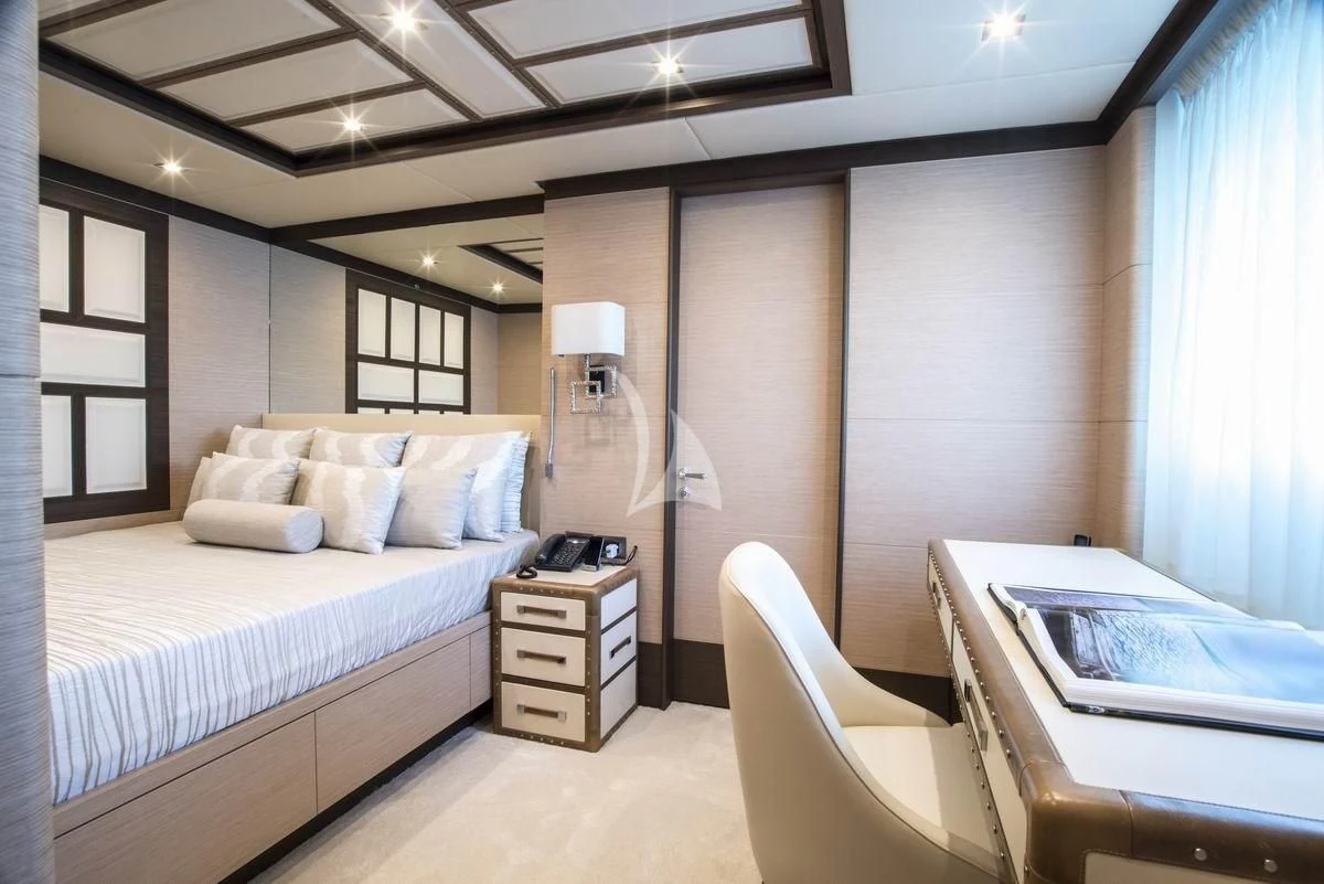 a room with a bed and a desk aboard NELA Yacht for Charter