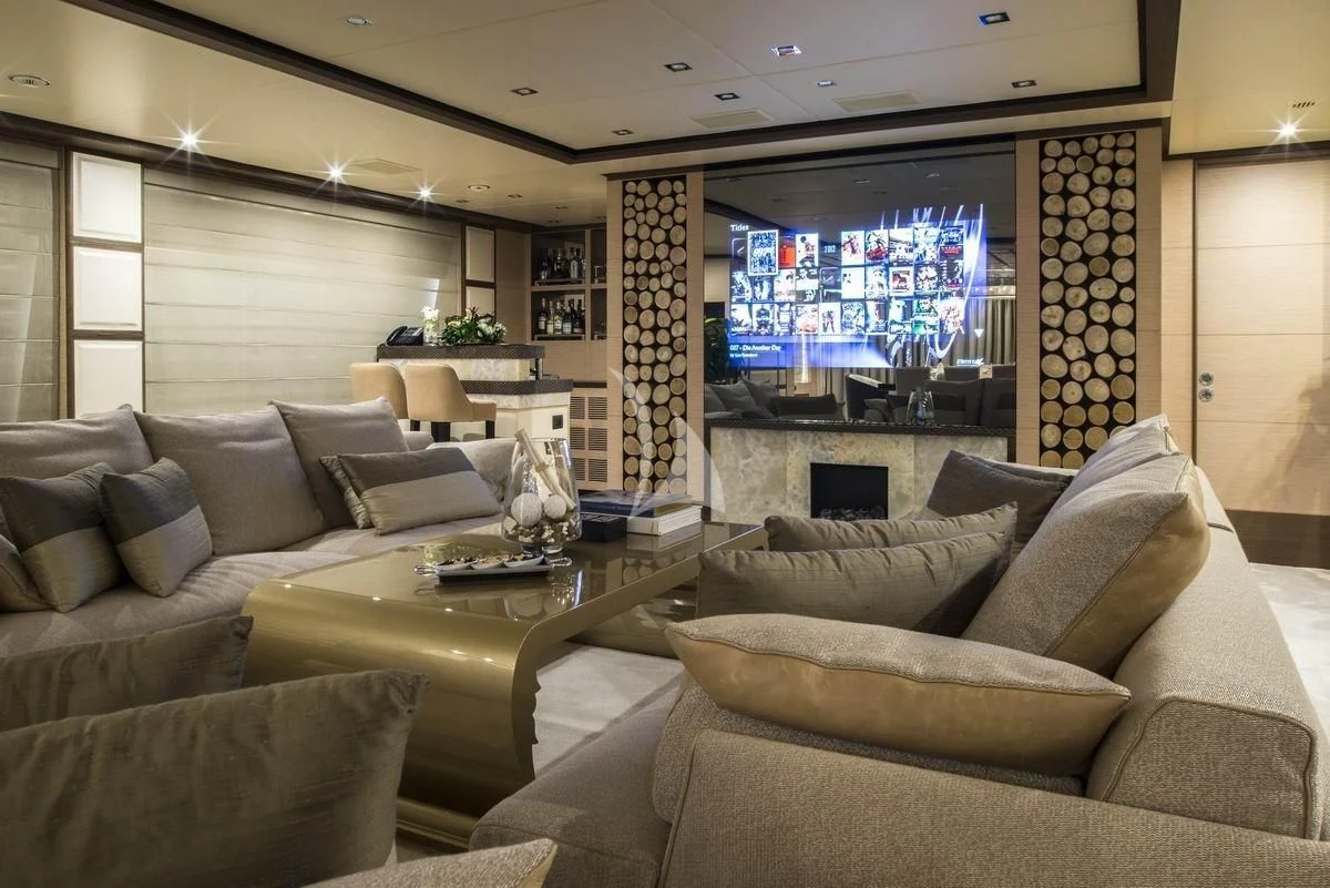 a living room with a large screen aboard NELA Yacht for Charter