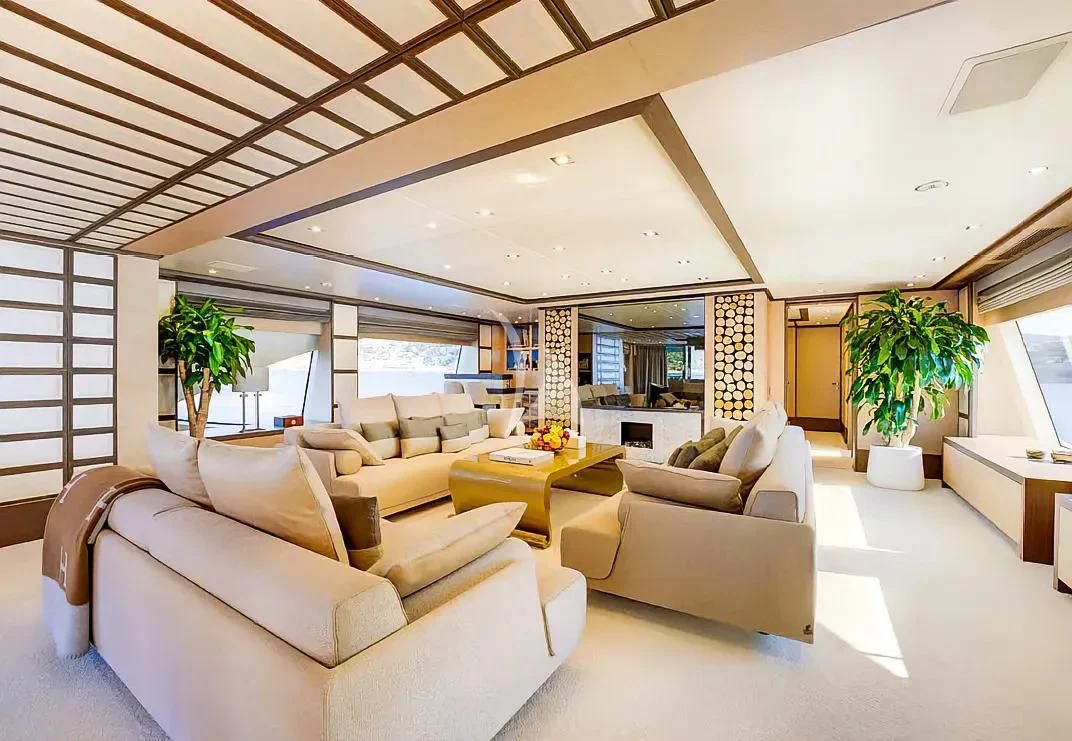 a living room with white furniture aboard NELA Yacht for Charter