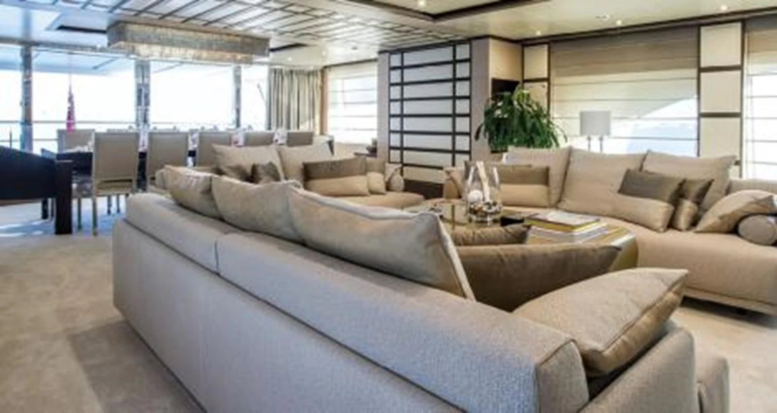 a large living room with a large window aboard NELA Yacht for Charter