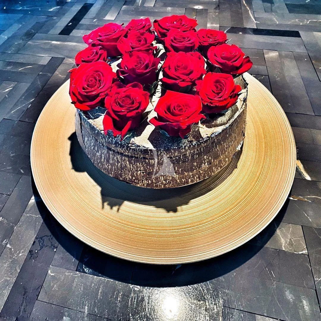 a cake with red roses aboard NELA Yacht for Charter